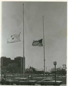 United States and Massachusetts flags at half-staff