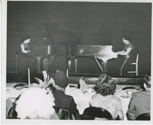 Women playing piano at Thanksgiving dinner