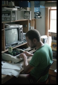 Ernie Allen in his home office, working on an Apple II computer