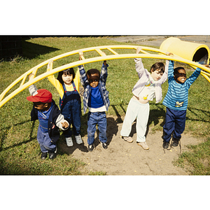 Young children under an outdoor play structure