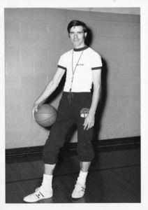 Assistant Basketball Coach James E. Nelson with basketball and whistle