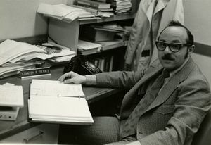 Suffolk University Professor Stanley R. Dennis (Accounting) sitting at a desk