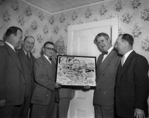 Five men posing with Thomas P. O'Neill and cartoon of Thomas P. O'Neill drawn by Joe Beesan