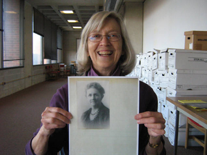 Susan Steele holding a photograph of her great-grandmother Catherine Desmond McShane