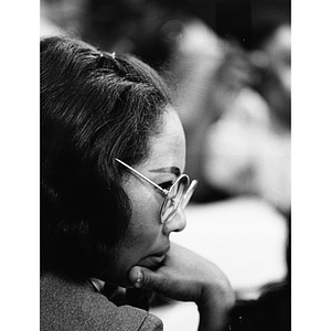 Profile of an unidentified female staff member of La Alianza Hispana, turned to the right and wearing eyeglasses