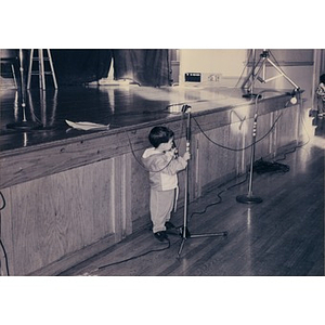 Small boy playing with the microphone at the Jorge Hernandez Cultural Center.