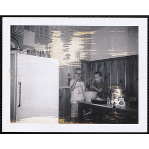 Two boys from the Charlestown Boys' Club preparing food in the kitchen