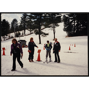 A boy on skis receives instruction at a resort