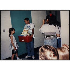 A man talks to a girl at an End of Year Party