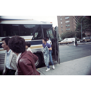 Members of the Chinese Progressive Association exit a charter bus