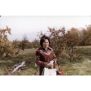 Woman in an orchard during a Chinese Progressive Association trip