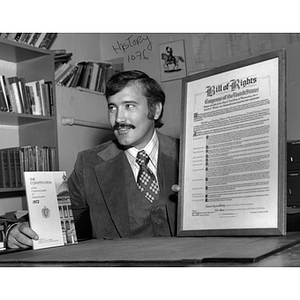 Professor William Fowler poses with the Massachusetts Constitution and the national Bill of Rights