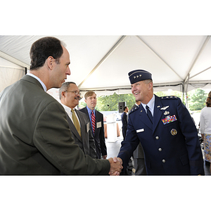Lieutenant General Ted F. Bowlds shakes hands with a guest at the groundbreaking ceremony