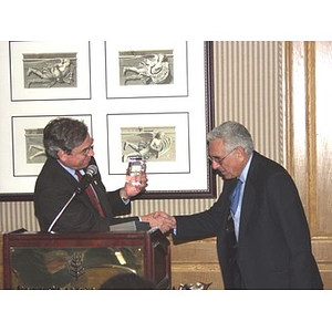 President Richard Freeland shaking hands with John Hatsopoulos, right, for his establishment of a scholarship program