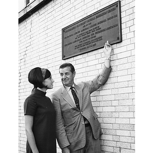 Herbert Gallagher, Director of Athletics, and his daughter Wendy look at the Cabot building plaque