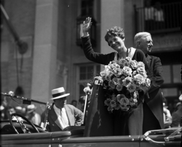 Amelia Earhart waving to crowds