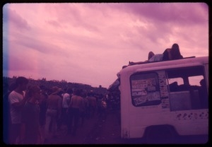 Crowd around a food truck as evening falls during the Woodstock Festival