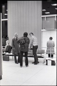 Richard Safft talking with people in waiting area at JFK airport