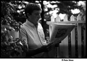 John Updike portrait with newspaper