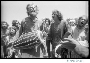Bhagavan Das drumming on the lawn during Ram Dass's appearance at Sonoma State University, Peter Simon recording his singing
