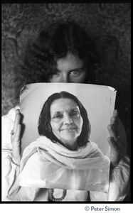 Usha (Cathy Brown) holding up a portrait of an unidentified woman