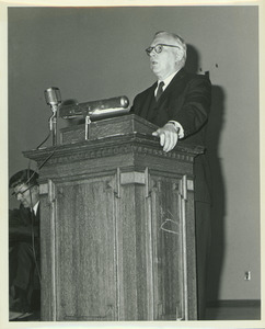 Louis M. Lyons behind podium