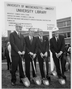 John W. Lederle standing outdoors with three unidentified men at groundbreaking ceremony for University Library