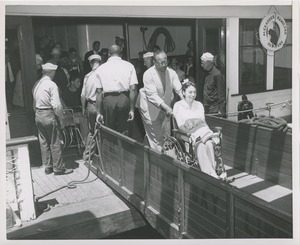 Woman in wheelchair disembarks from boat