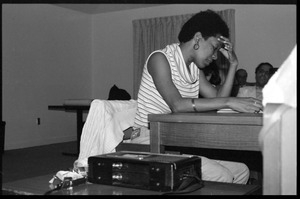 Nancy Morejón, Cuban writer, speaking at the Institute for the Humanities, UMass Amherst, seated, reading from her book