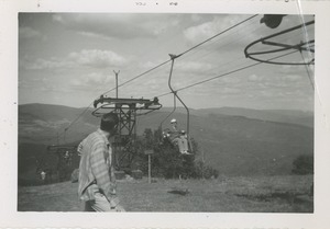 Unidentified man observing an out of season ski lift