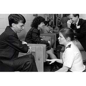 A woman speaking with a man at the Law School Open House, 1985