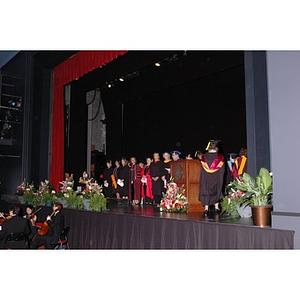 Faculty members walk onstage at School of Nursing convocation