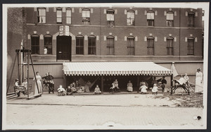 Two caregivers and a group of children in yard of a children's mission, 68 Warrenton Street, Boston, Mass., undated