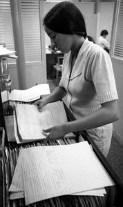 Office worker filing papers