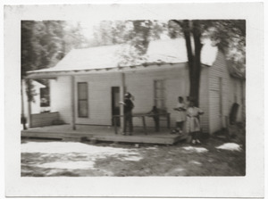 Children standing by a ping pong table on porch of Rust Avenue house rented by the Congress of Federated Organizations (COFO)