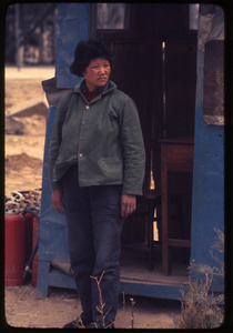 Petrochemical plant -- woman standing by gatehouse