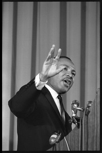 Martin Luther King, Jr., speaking from a podium