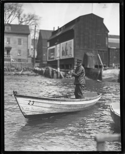 John P. Johnson ("Armless Johnson") working on a small rowboat