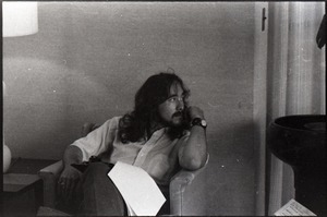 Unidentified man seated in a chair, probably in the UMass Student Union