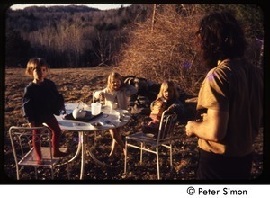 Children playing outside at a table, Tree Frog Farm Commune