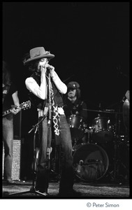 Bob Dylan performing on harmonica at the Harvard Square Theater, Cambridge, with the Rolling Thunder Revue