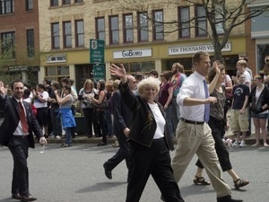 Marchers waving to the crowd during the Pride Parade; Main Street, Northampton, Mass.