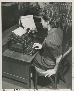 A woman learns one-handed typewriting at TOWER clerical training