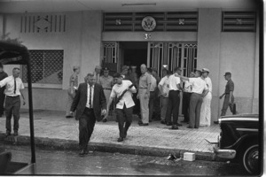 Wounded Ambassador U. Alexis Johnson evacuates the Embassy after the explosion; Saigon.