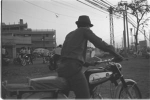 Vietnamese motorbike drivers waiting for customers in the evening at the gate of the Ton Son Nhut Airbase; Saigon.