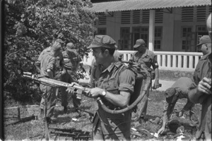 Associated Press' Peter Arnett testing the first flame thrower captured from the Vietcong in Vietnam.