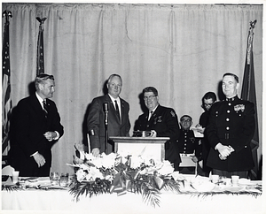 Massachusetts Attorney General Eddie McCormack and Mayor John F. Collins with unidentified men in uniform