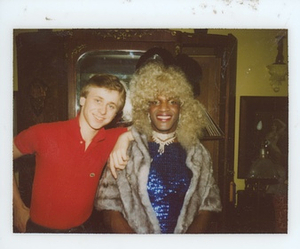 A Photograph of Marsha P. Johnson Posing in a Sparkly Blue Gown Next to Her Roommate