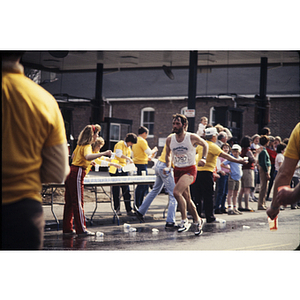 View of YMCA staff in yellow shirts and runners during Boston Athletic Association (BAA) marathon