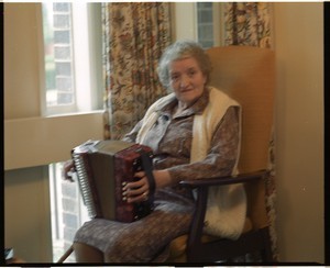 Old woman playing the accordion, Derry